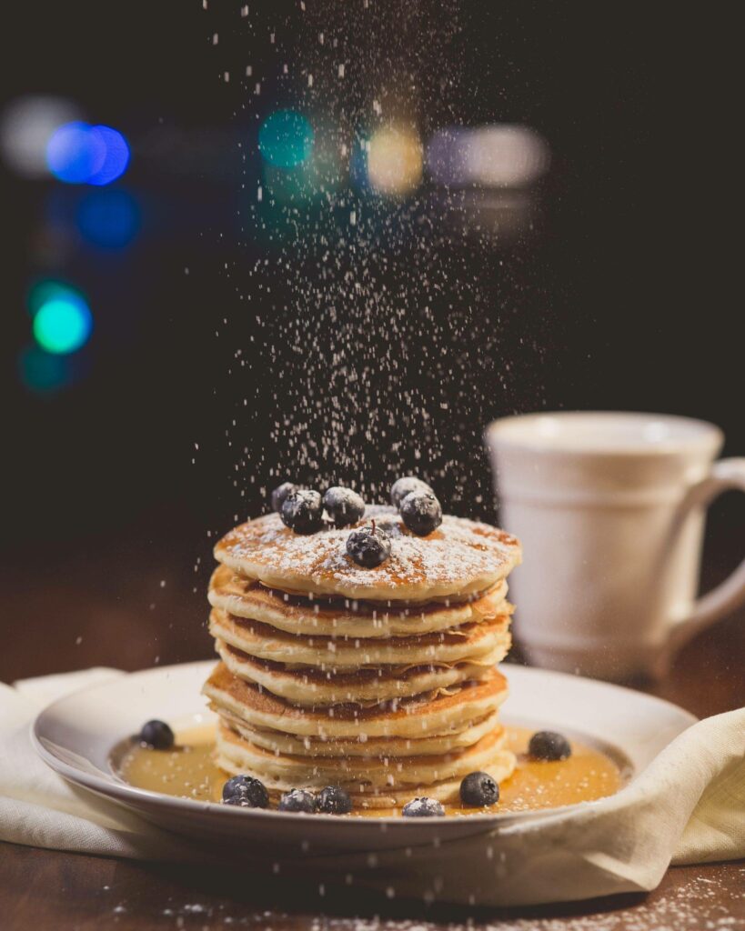 quinoa pancakes topped with blueberries and sprinkled with powdered sugar gecko hospitality