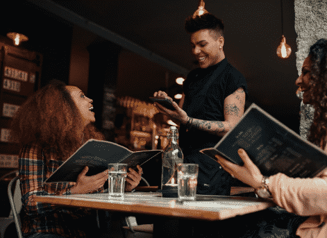 Customer service employee taking an order at a hospitality establishment